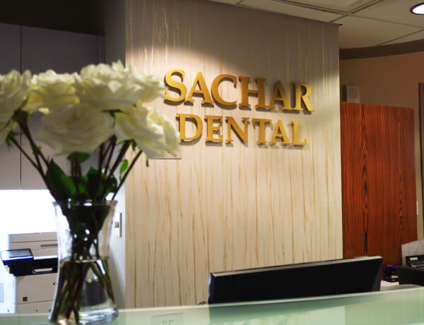 Dentist NYC - Sachar dental NYC logo over the front desk. Sachar dental NYC